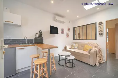 a kitchen and living room with a couch and a table at VCA House -5 appartements - 15Min Mer- Wifi-Clim in Cannes