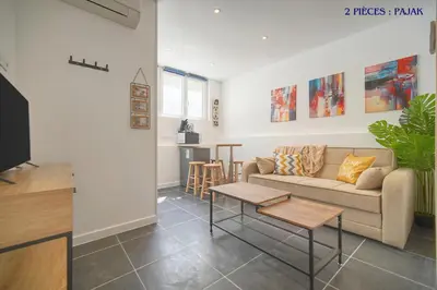 a living room with a couch and a table at VCA House -5 appartements - 15Min Mer- Wifi-Clim in Cannes