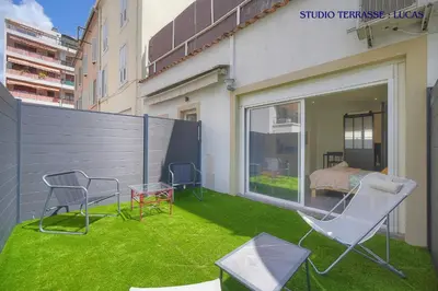 two chairs and chairs on a balcony with grass at VCA House -5 appartements - 15Min Mer- Wifi-Clim in Cannes