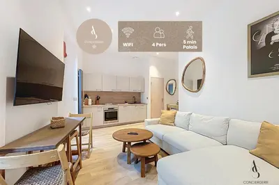 a living room with a couch and a table at Le Forville - 2 chambres - 5 min Palais - Suquet in Cannes