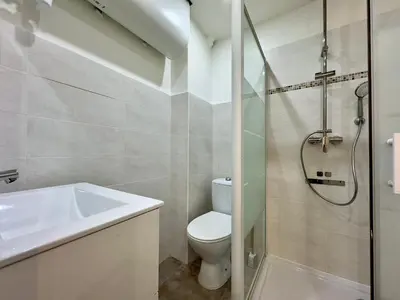a bathroom with a toilet and a sink and a shower at Le Versailles By SCLS Locations in Cannes