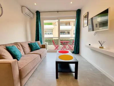 a living room with a couch and a table at Le Versailles By SCLS Locations in Cannes