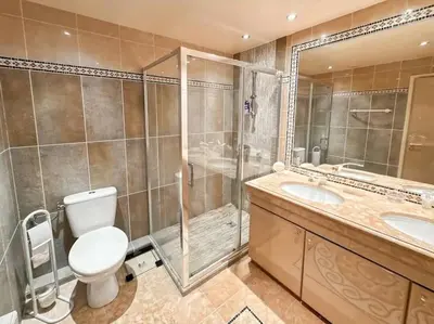 a bathroom with a toilet and two sinks and a shower at Appt 2ch 90m2 avec terrasse 40m2, piscine et tennis in Cannes