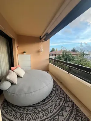 a bedroom with a large round bed on a balcony at Appt 2ch 90m2 avec terrasse 40m2, piscine et tennis in Cannes