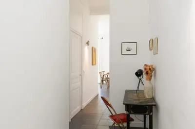 a hallway with a table with a vase on it at Immogroom - Renovated & Cozy One-Bedroom Flat in Cannes