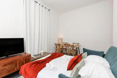 a living room with a bed and a tv at Immogroom - Renovated & Cozy One-Bedroom Flat in Cannes