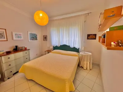 a bedroom with a bed and a dresser and a window at Two rooms near Martinez in Cannes