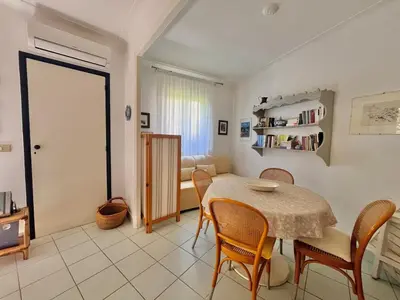 a kitchen and dining room with a table and chairs at Two rooms near Martinez in Cannes