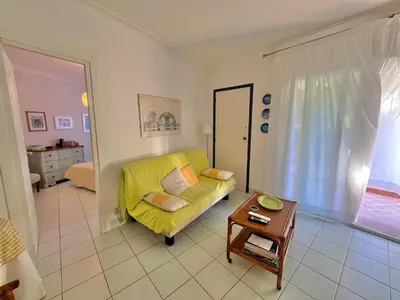 a living room with a yellow couch and a table at Two rooms near Martinez in Cannes