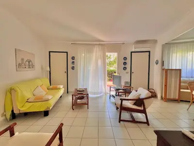 a living room with a yellow couch and chairs at Two rooms near Martinez in Cannes