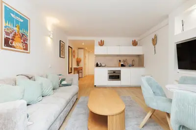 a living room with a couch and a table at El Sole - Plage - Wifi - Croisette in Cannes