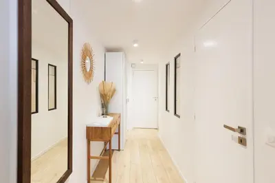 a hallway with white walls and a mirror at El Sole - Plage - Wifi - Croisette in Cannes