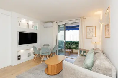 a living room with a couch and a table at El Sole - Plage - Wifi - Croisette in Cannes
