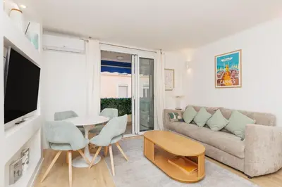 a living room with a couch and a table at El Sole - Plage - Wifi - Croisette in Cannes