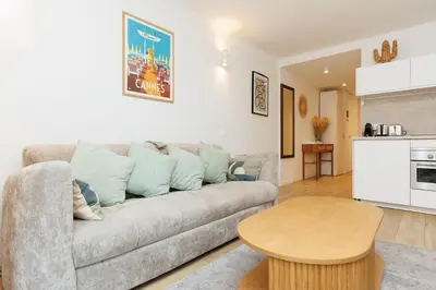 a living room with a couch and a table at El Sole - Plage - Wifi - Croisette in Cannes