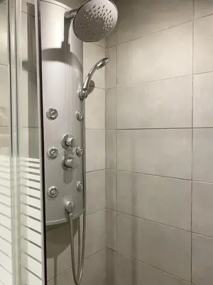 a white bathroom with a sink and a shower at Antibes Bis in Cannes
