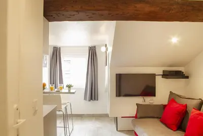 a kitchen with a sink and a table with fruit at Antibes Bis in Cannes