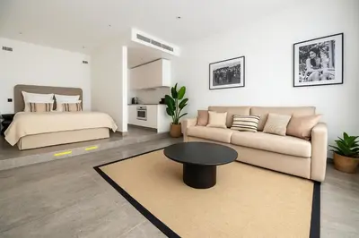 a living room with a bed and a couch and a table at Mediterranean Cosy Studio in Cannes