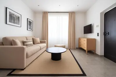 a living room with a couch and a table at Mediterranean Cosy Studio in Cannes