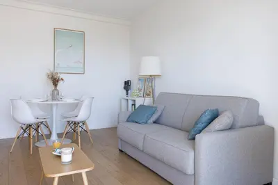 a living room with a couch and a table at Perchoir - Balcon, vue sur la ville, Palais&Plages in Cannes