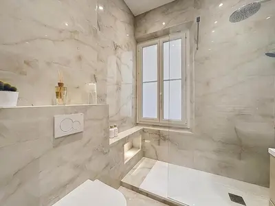 a bathroom with a shower and a toilet and a window at Effet Mer - neuf, central, Port, Plage&Palais, clim in Cannes