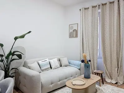 a living room with a couch and a table at Effet Mer - neuf, central, Port, Plage&Palais, clim in Cannes