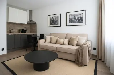 a living room with a couch and a table at Croisette Cosy Studio in Cannes