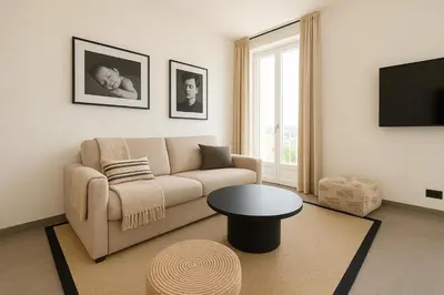 a living room with a couch and a table at Seaview Studio, Palais des Festivals in Cannes