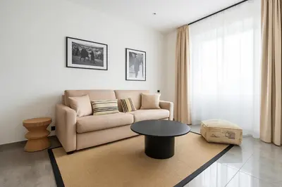 a living room with a couch and a table at Seaview Studio, Palais des Festivals in Cannes