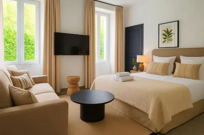 a bedroom with two beds and a couch at Croisette Palais des Festivals Studio in Cannes