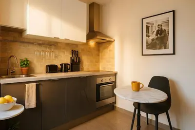 a kitchen with a small table and a counter at Croisette Palais des Festivals Studio in Cannes