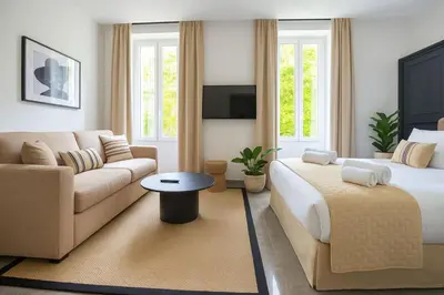 a living room with a bed and a couch at Croisette Palais des Festivals Studio in Cannes