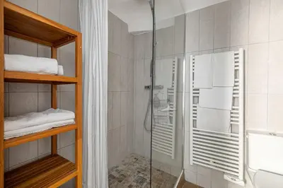 a shower in a bathroom with a glass shower stall at LA MAISON DU SUQUET duplex avec terrasse en plein centre in Cannes