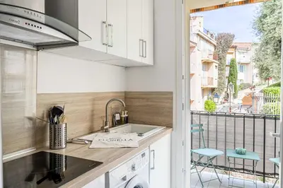a kitchen with a sink and a balcony at LA MAISON DU SUQUET duplex avec terrasse en plein centre in Cannes