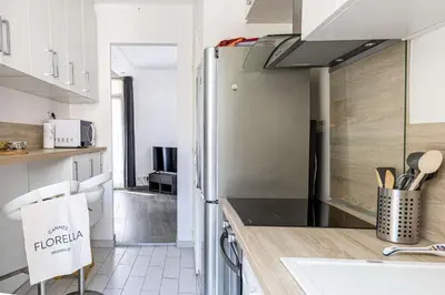a kitchen with a stainless steel refrigerator at LA MAISON DU SUQUET duplex avec terrasse en plein centre in Cannes