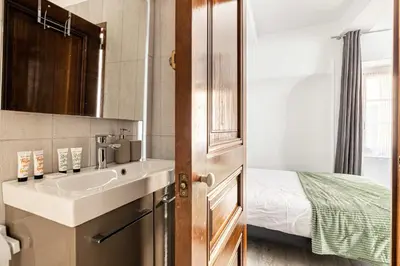 a small bathroom with a sink and a bed at LA MAISON DU SUQUET duplex avec terrasse en plein centre in Cannes