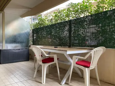 a white table and two chairs on a patio at Pause Riviera avec terrasse, à 300 mètres de la mer in Cannes