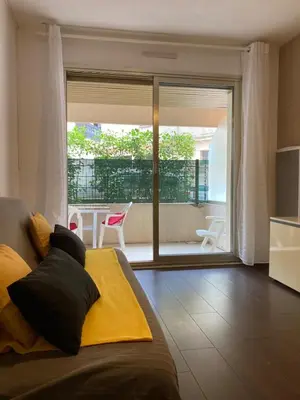 a bedroom with a bed and a view of a patio at Pause Riviera avec terrasse, à 300 mètres de la mer in Cannes