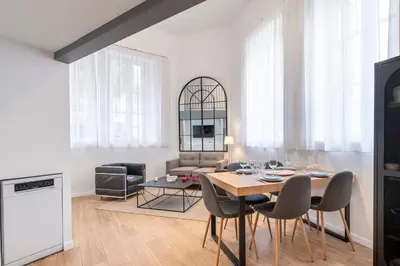 a dining room and living room with a table and chairs at Cosy T2 in Cannes in Cannes