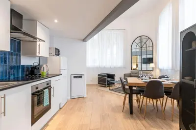 a kitchen and dining room with a table and chairs at Cosy T2 in Cannes in Cannes
