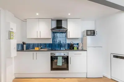 a kitchen with white cabinets and an oven at Cosy T2 in Cannes in Cannes