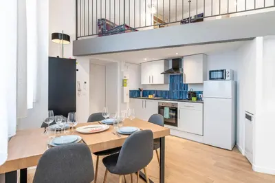 a kitchen and dining room with a table and chairs at Cosy T2 in Cannes in Cannes