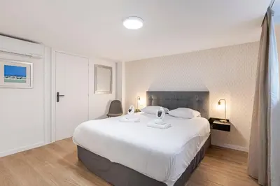 a bedroom with a large white bed in a room at Cosy T2 in Cannes in Cannes