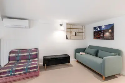 a living room with a couch and a stool at Cosy T2 in Cannes in Cannes