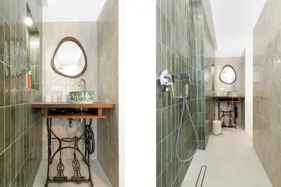 a bathroom with green tiles and a shower at Modern 2 Bedroom Overlooking Cannes Old Port in Cannes