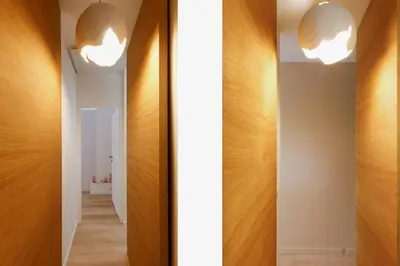 a hallway with wood paneling and two lights at Modern 2 Bedroom Overlooking Cannes Old Port in Cannes