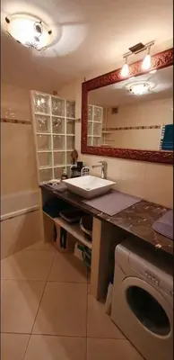 a bathroom with a sink and a washing machine at Logement très confortable et bien situé à Cannes in Cannes
