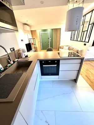 a kitchen with white cabinets and a sink at Studio La Baronne in Cannes
