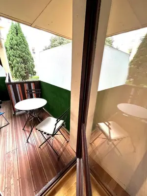 a balcony with two chairs and a table and a window at Studio La Baronne in Cannes