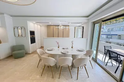 a dining room with a white table and chairs at Wide and sunny 3 BR 2 Baths heart of Cannes gorgeous terrace city ctr in Cannes